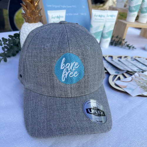 Gray cap with a blue 'breathe free' logo on a light blue surface